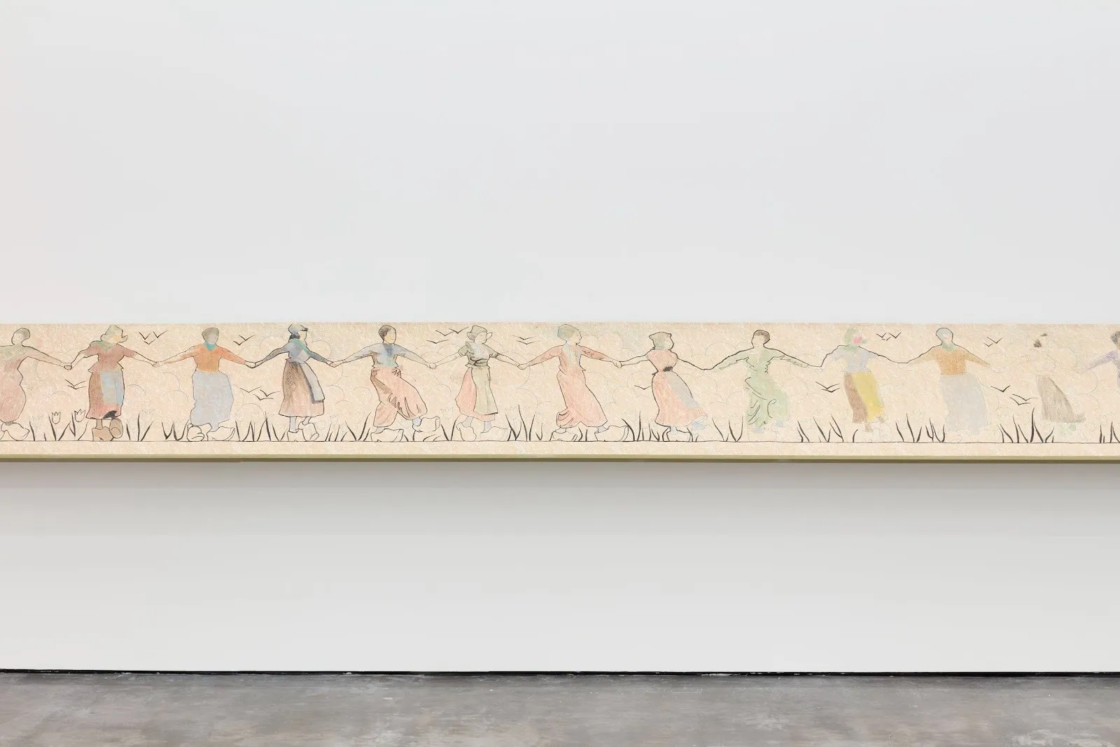 Long strip of wood with colorful drawings of farm workers holding hands and dancing, ana jotta installation view of on peut on peut at wiels brussels.