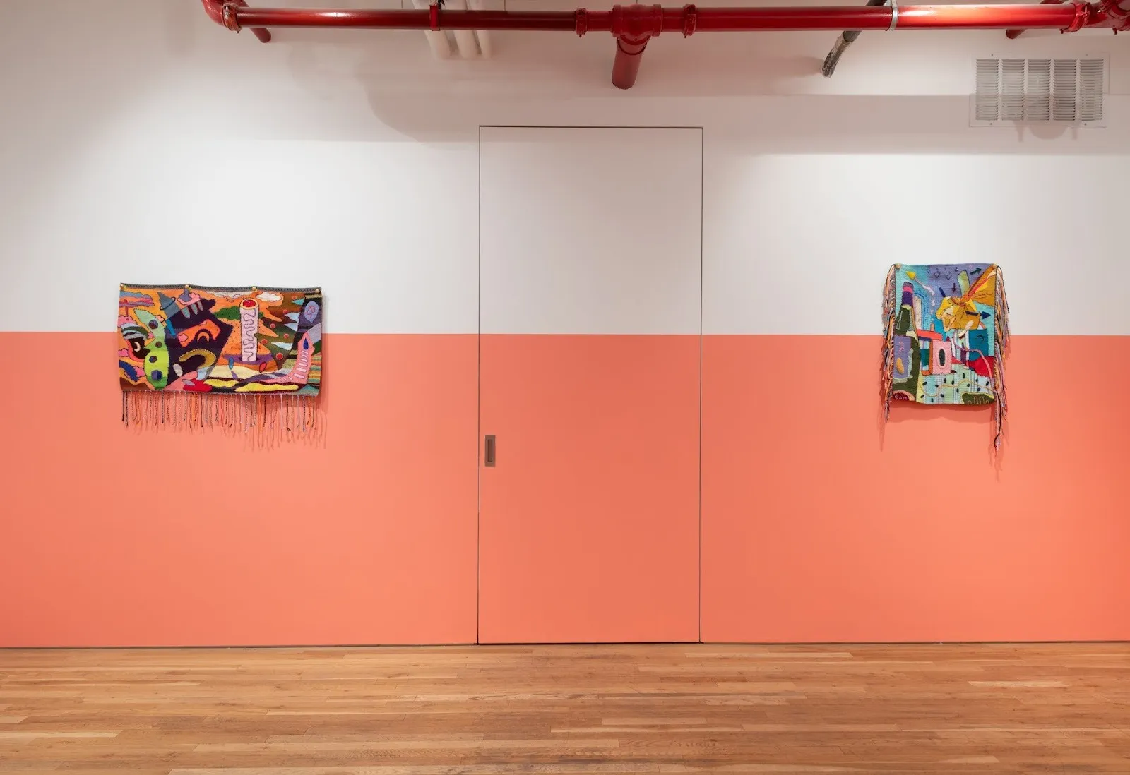 Colorful cartoonish tapestries installed on white and orange wall in Jane Lombard Gallery, work by sam dienst, cartoon logic, impulse magazine interview.
