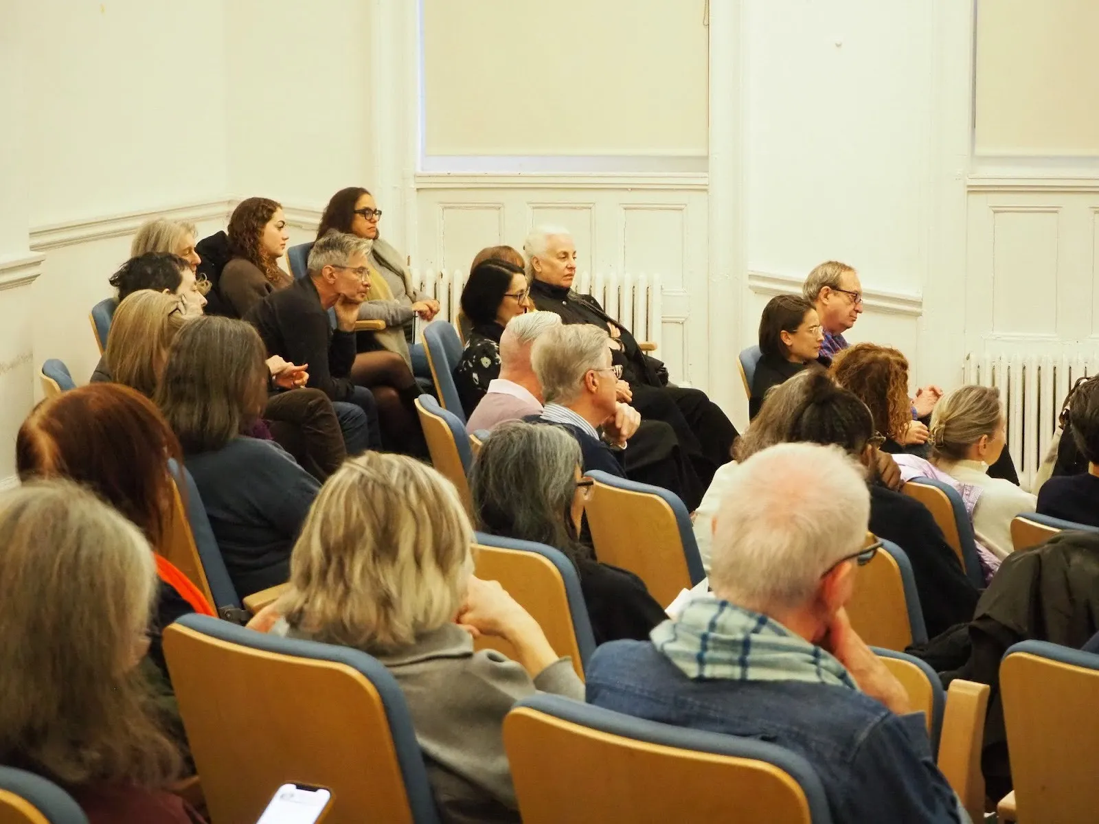 An attentive audience listen to the panel discussion that follows the soho premiere of on this spot nyc at nyu's auditorium.
