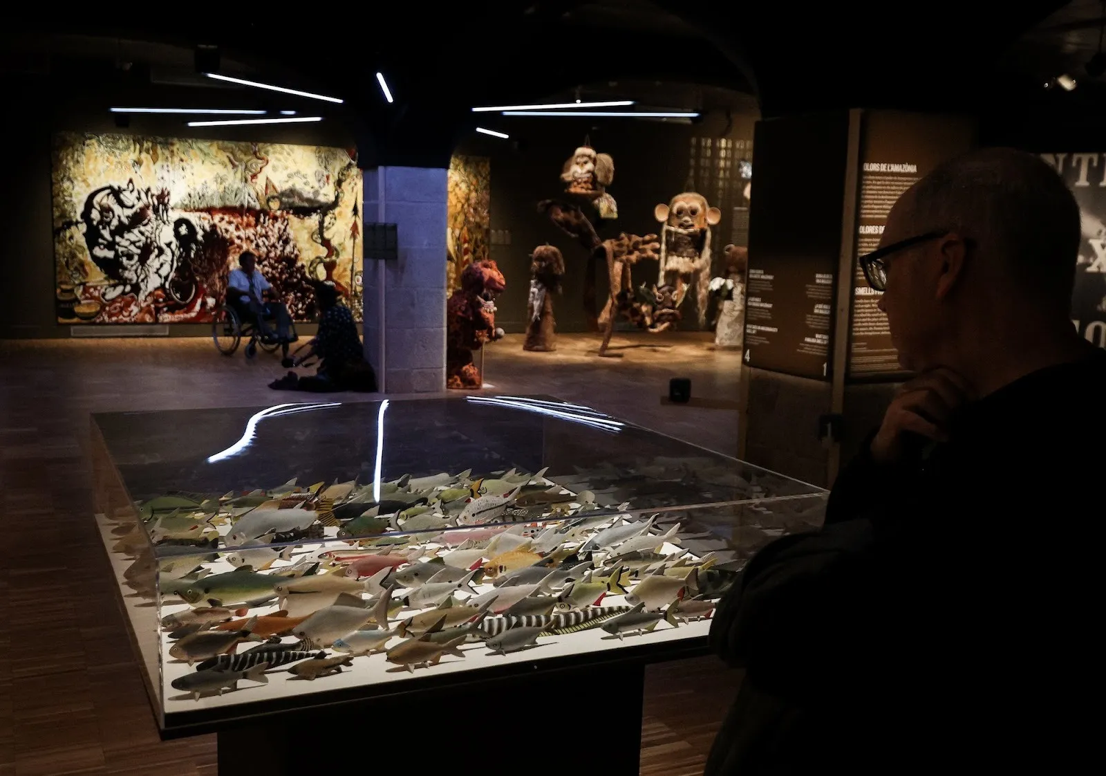 Installation view of amazons, the ancestral future with statues of fish, indigenous mythical creatures, and large-scale mural, at the contemporary center of culture in barcelona.