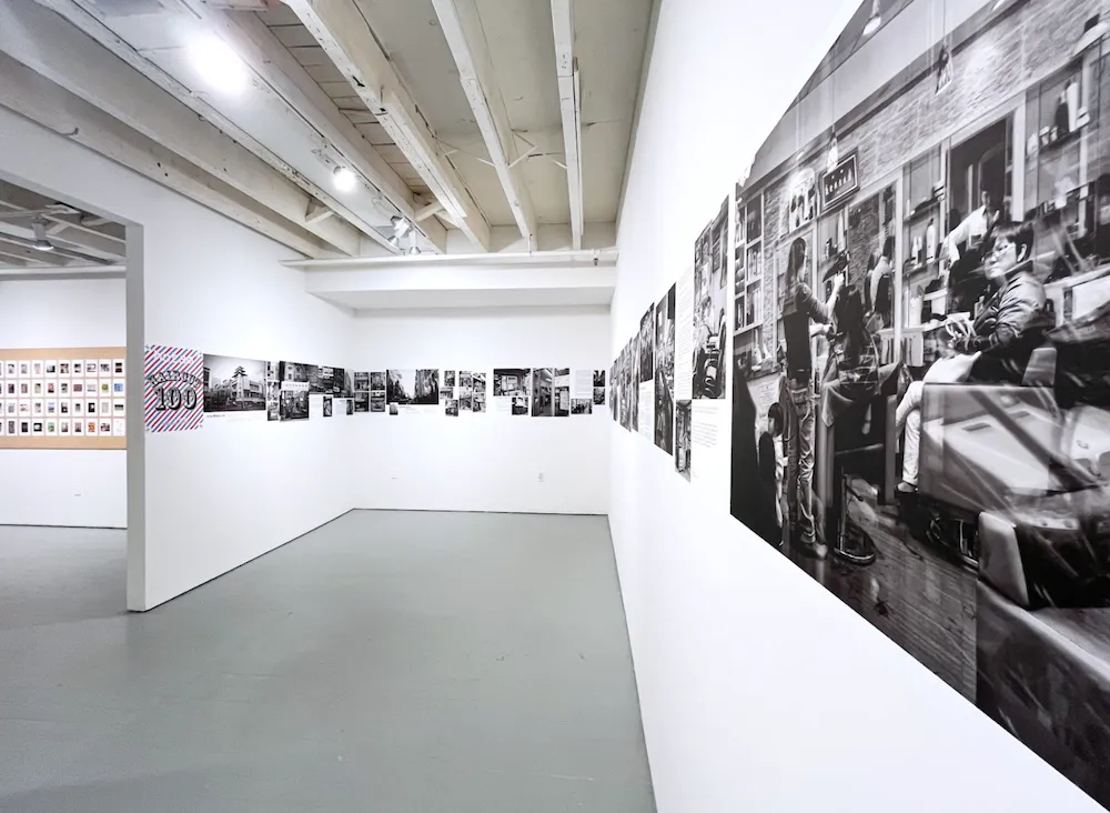 White gallery wall with a continuous strip of black and white photographs of chinese hair salons in manhattan's china town, ho tam haircut 100 solo photography exhibition at carriage trade.