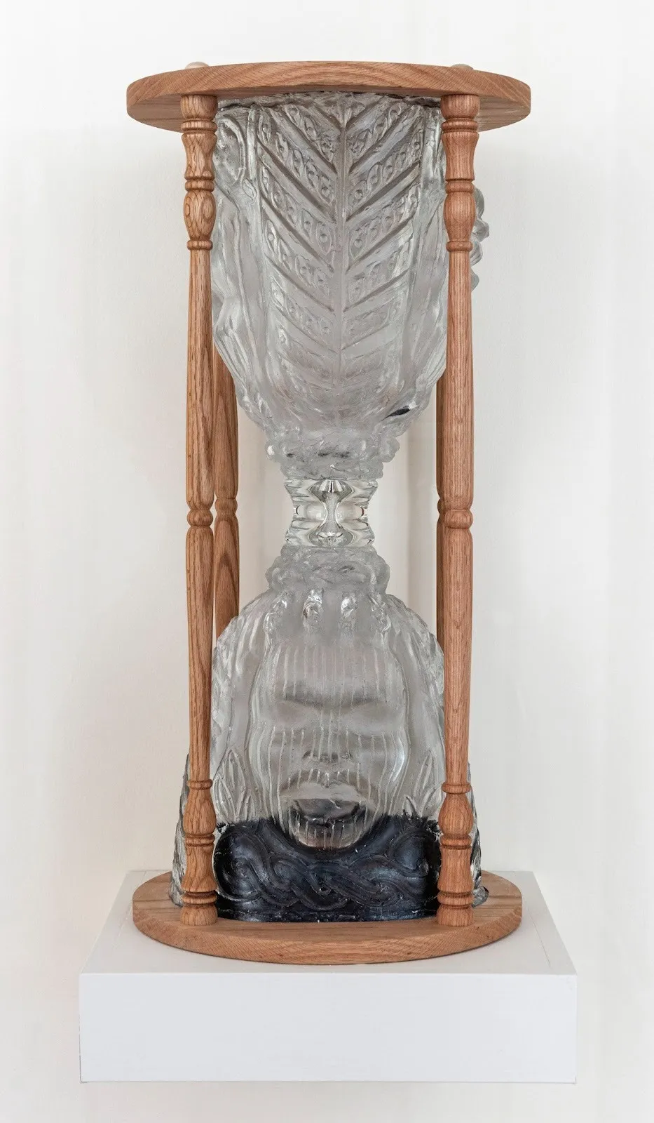Layo Bright, hourglass sculpture titled 9:29. May 25, 2020. George Floyd murder (2025). Mold-blown and blown glass, oak, and measured black sand of approximately 9 minutes 29 seconds.