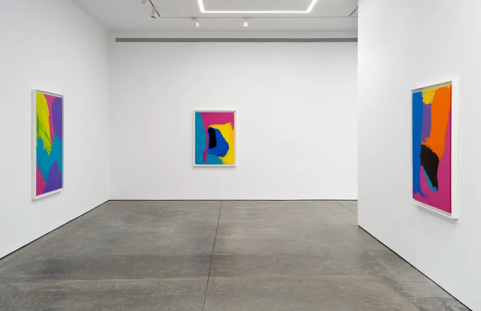 Three geometric abstraction paintings consisting of mostly blue, purple, orange and yellow on the walls of a white cube gallery, Mirdidingkingathi Juwarnda Sally Gabori, karma.