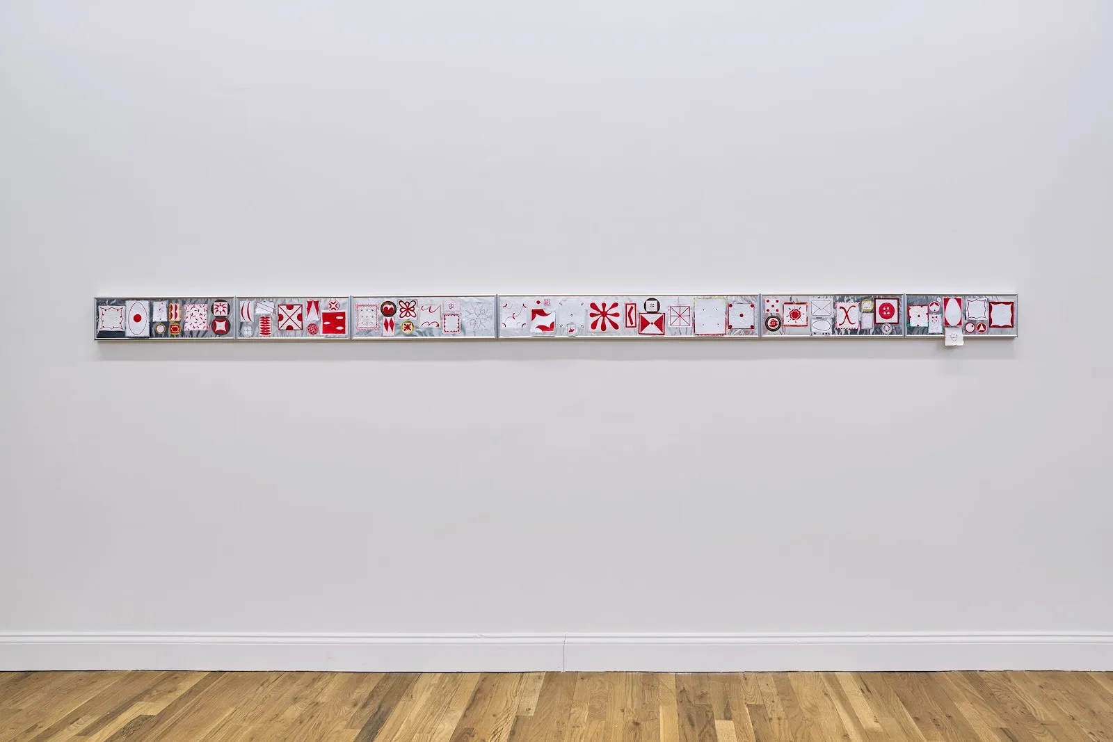 Long strip of aluminum foil with red geometric drawings taped on top, adam milner, solo exhibition meanwhile at rainrain gallery.