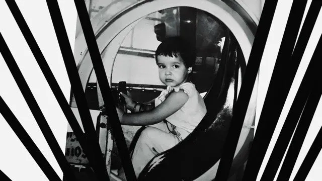 Black and white photo of a child sitting and looking at camera, chronicles of the absurd by miguel coyula and lynn cruz.
