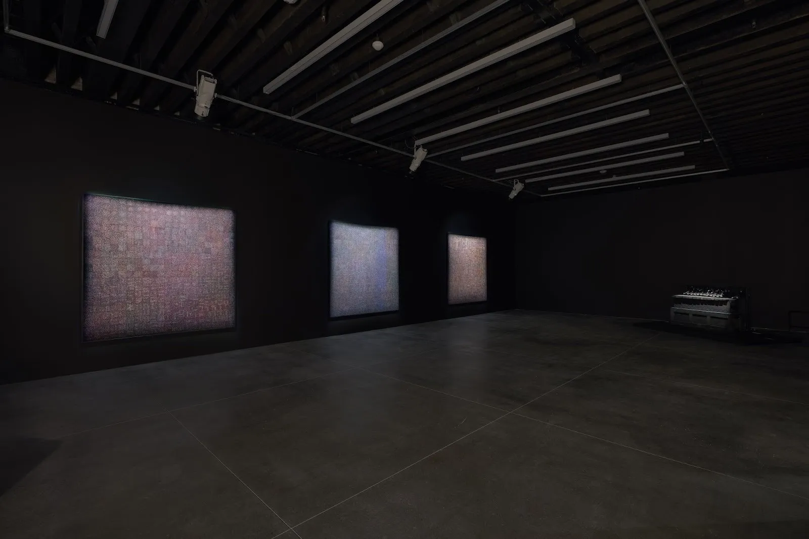 Three tapestry works with subtle thread installed on dark walls of Marian Goodman gallery, tavares strachan starless midnight solo exhibition.
