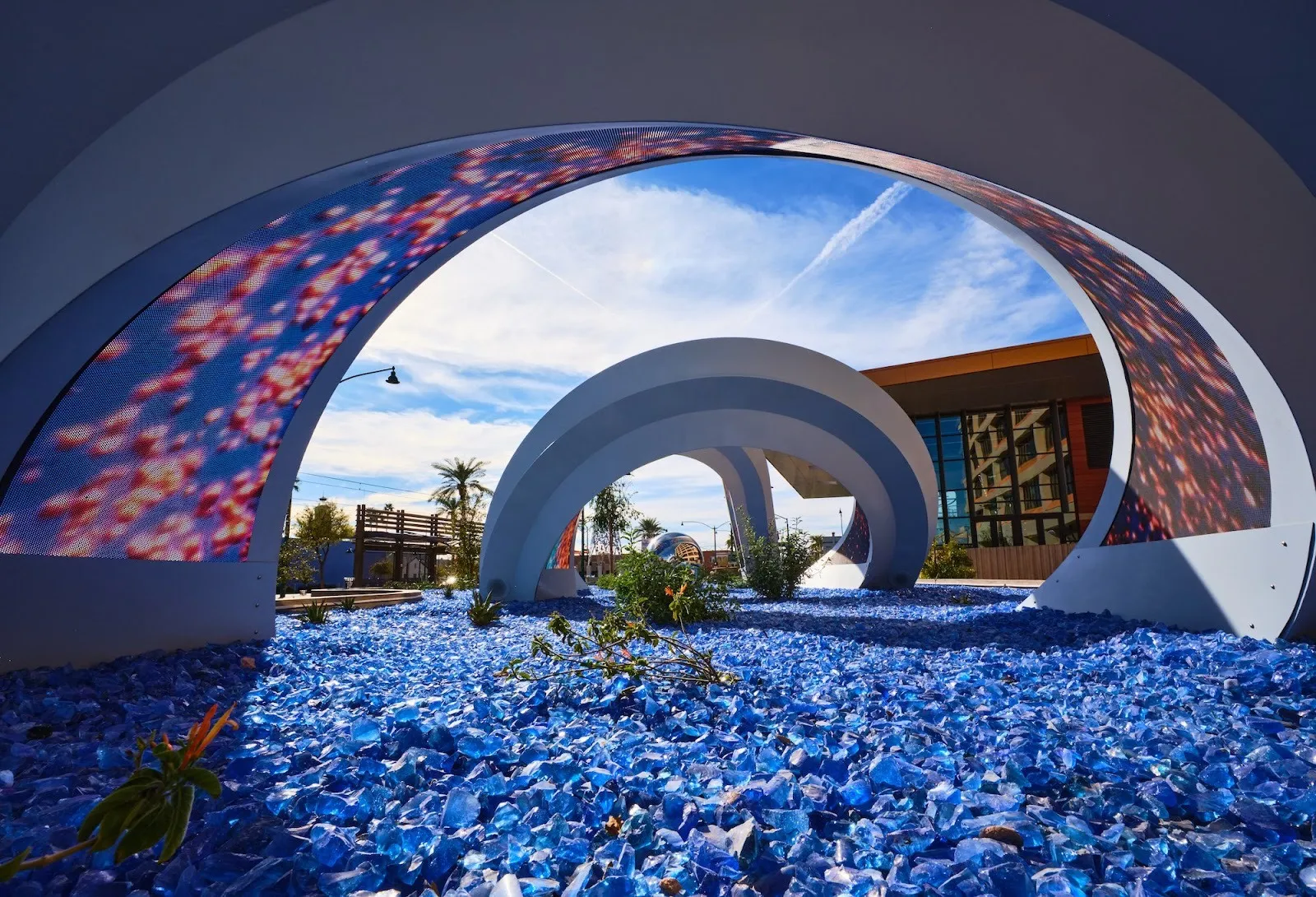 Adrian Yu and omer yosef Strata, 2024 public art installation in front of mesa city hall featuring spiral archways and LED panels with climate data visualization.