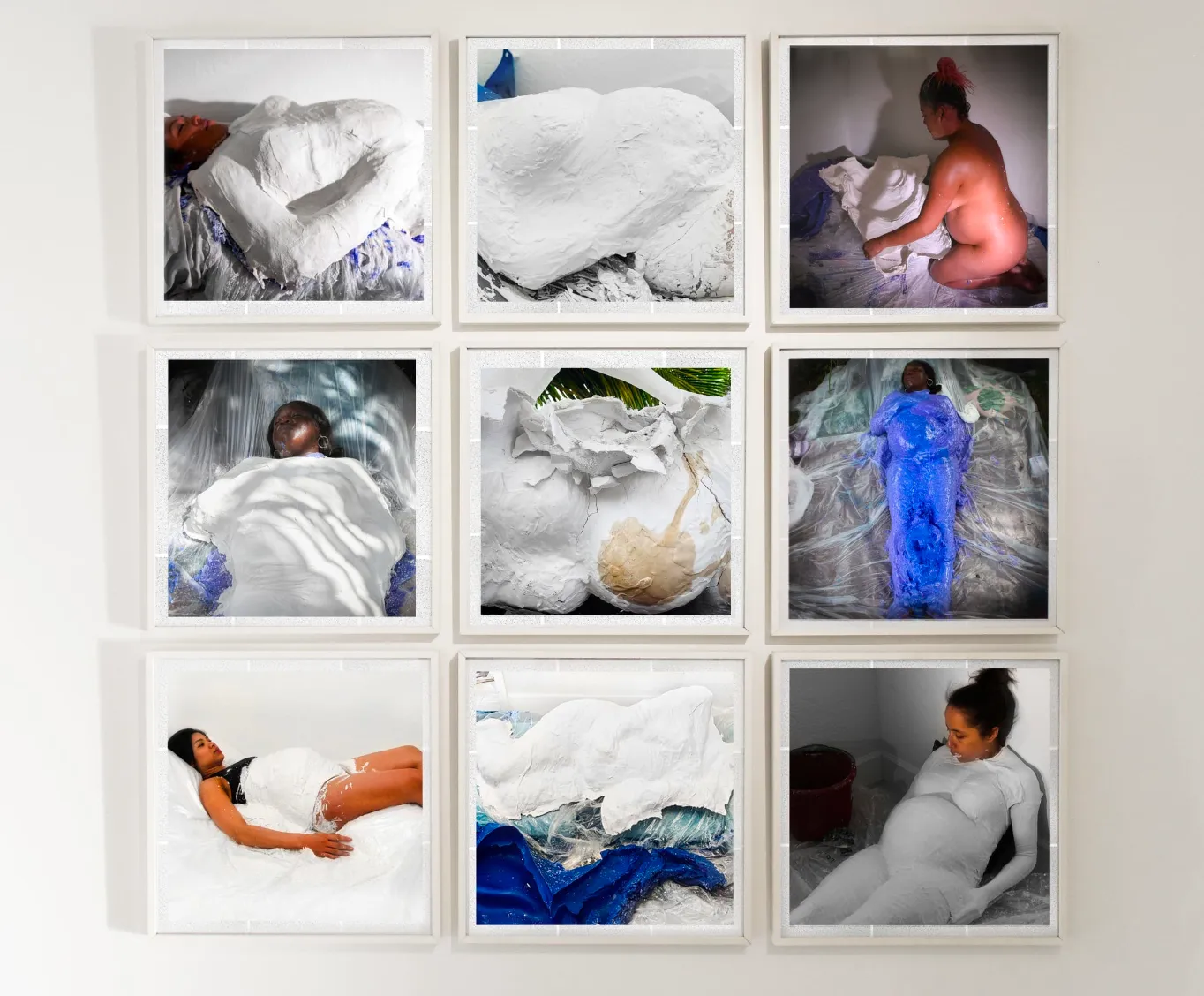 Frontal shot of one square photographs against a white wall configured in a square grid. Each photo depicts a pregnant subject in various states of rest and activity, often coated with different plaster and plastic material.