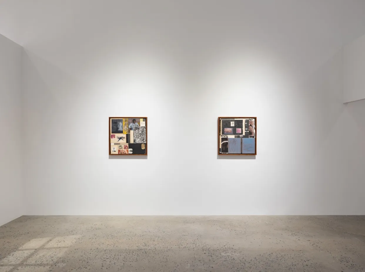 White gallery wall with concrete floor. On the back frontal wall, two square-framed collage works hang at the same level. Light from a window streams onto the floor.