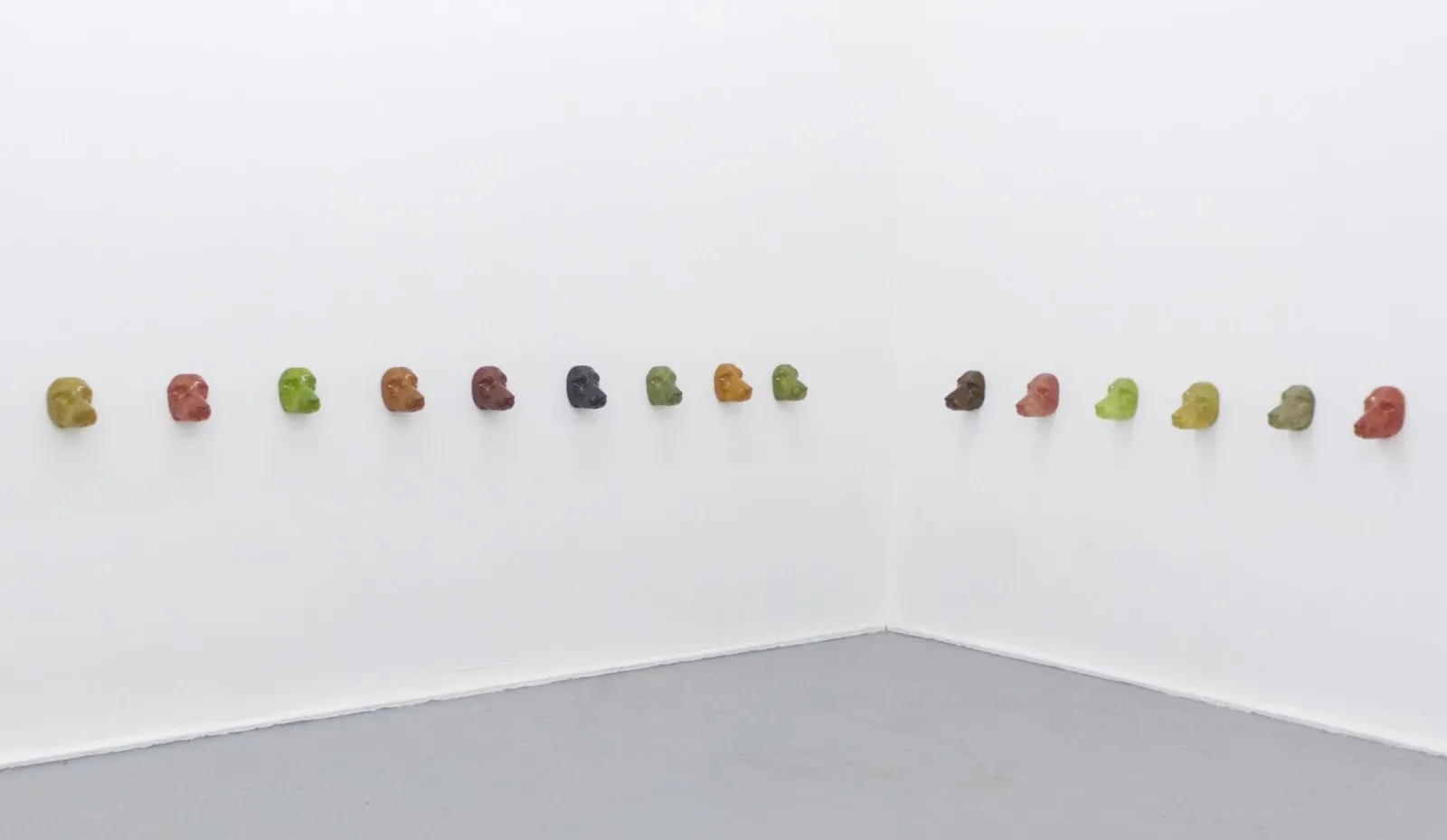 Alissa Ritter, Love, Treats and Power Play, 15 fiberglass sculptures of dog heads installed on gallery wall, yveyang gallery group show sehnsucht longing.