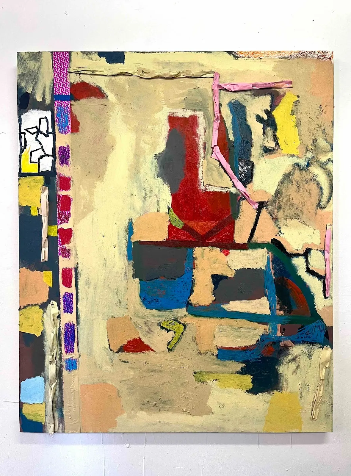 An abstract painting is made up of amorphous, slightly geometric shapes of red, tan, and off-white. The painting features visible brushstrokes and mark-making.