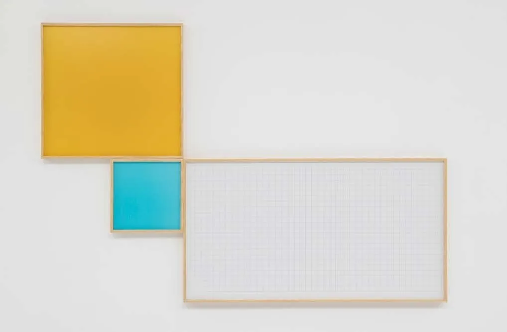 Three different 2D pieces, one square and yellow, one smaller-squared and cyan, and one rectangular with graph-like grids are joined together at the corners, their thin wooden frames flush against each other.