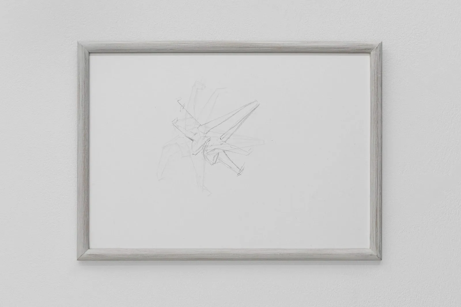 A minimalist pencil drawing of abstract, intersecting geometric lines, framed in light wood and hung on a white wall.