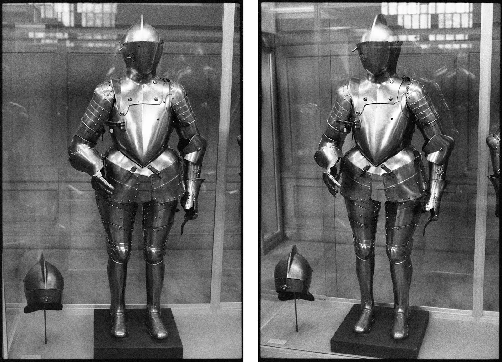 Two black and white photographs, side-by-side, feature a suit of armor from a frontal angle and a three-quarter angle. The medieval armor sits behind a glass display case, reflections visible on the glass.