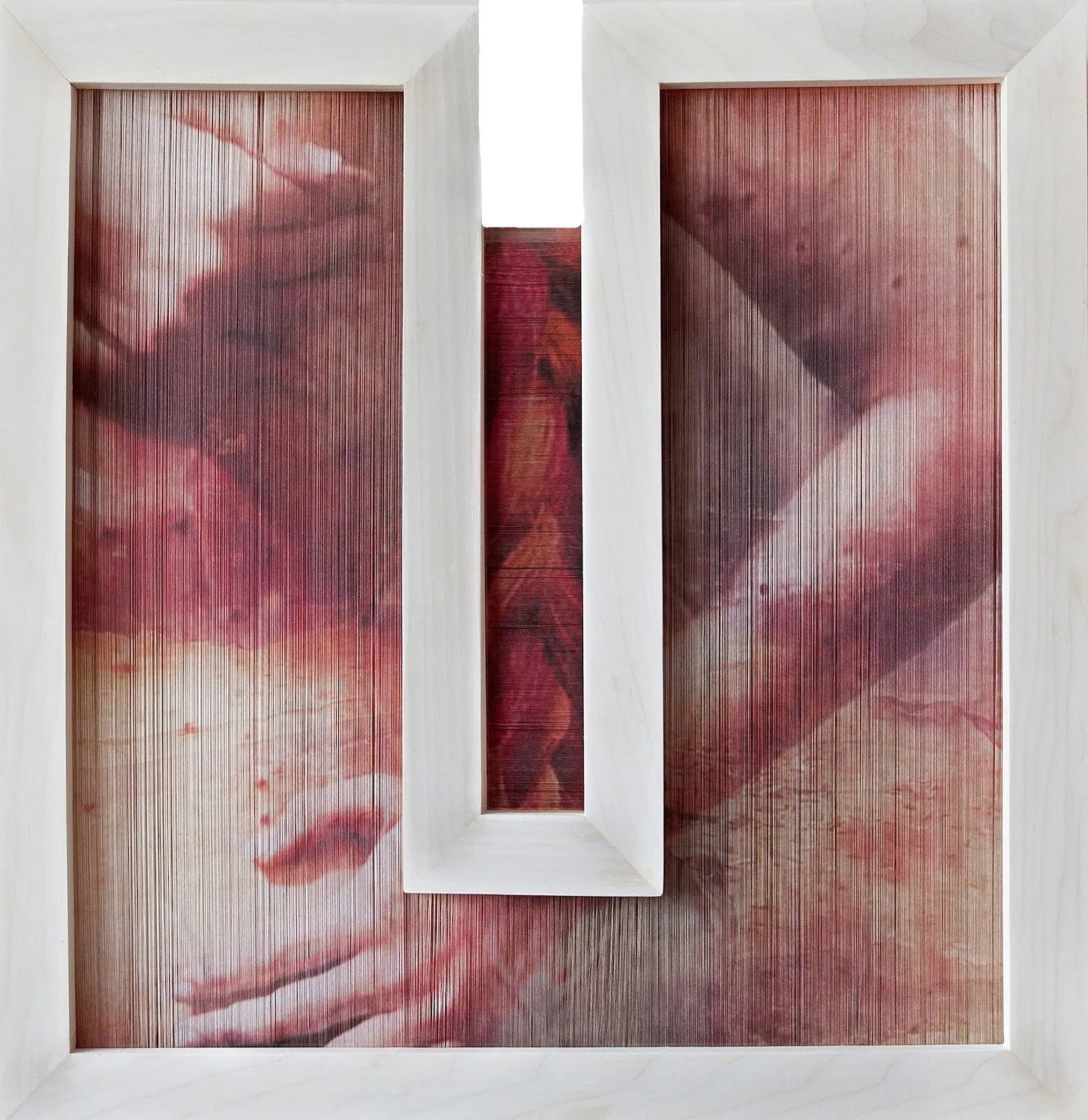 A connected, diptych-like wooden frame is threaded by a tight, opaque layer of threads. Printed upon the thread is an abstracted image of a body rendered in dusty red hues.