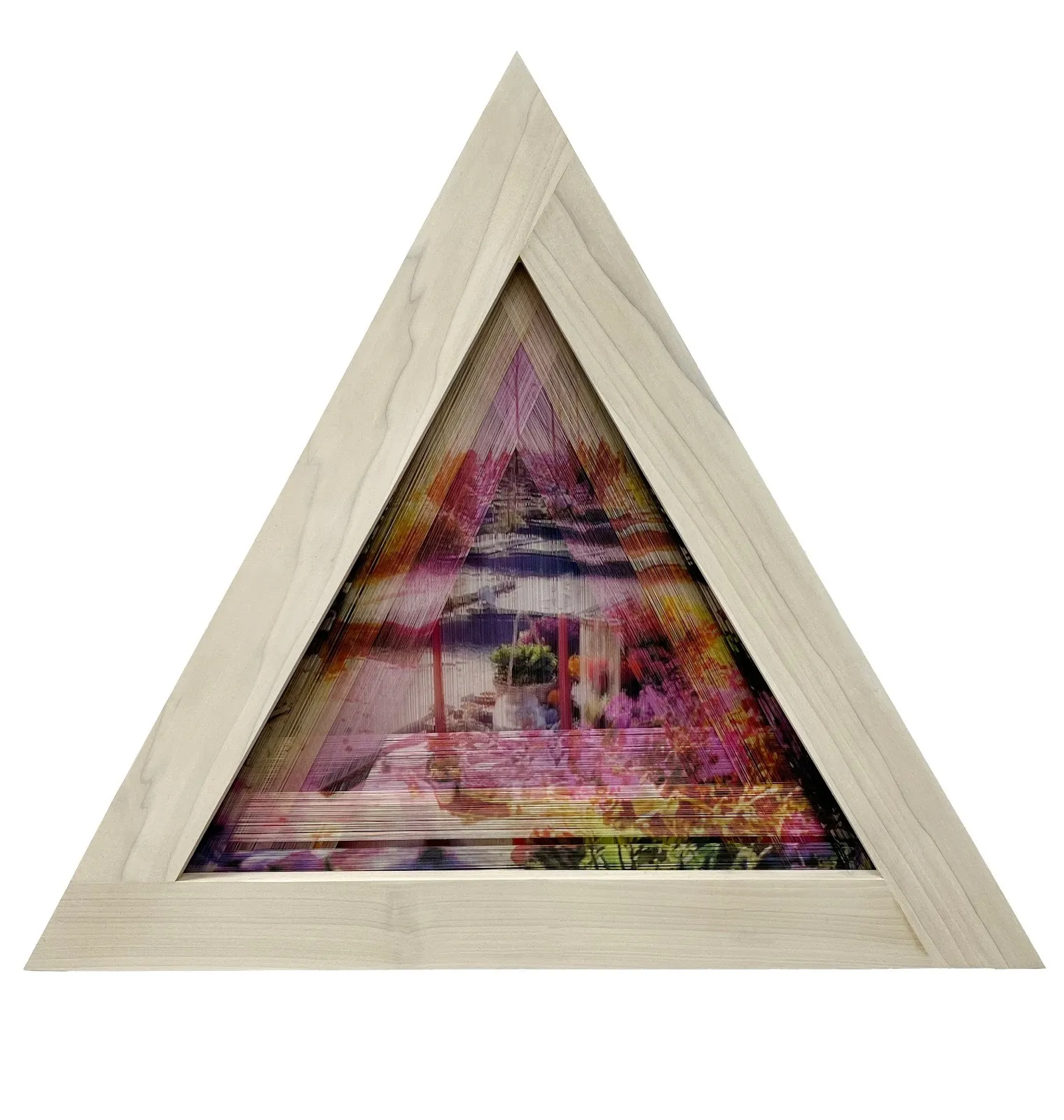 A triangle-shaped wooden frame supports multiple layers of stretched thread. Printed on the layers of thread are multiple superimposed and layered images.