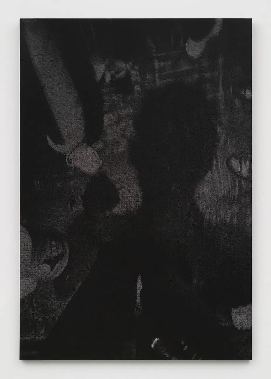 Dark photograph showing a human shadow cast among feet and shoes on the ground.