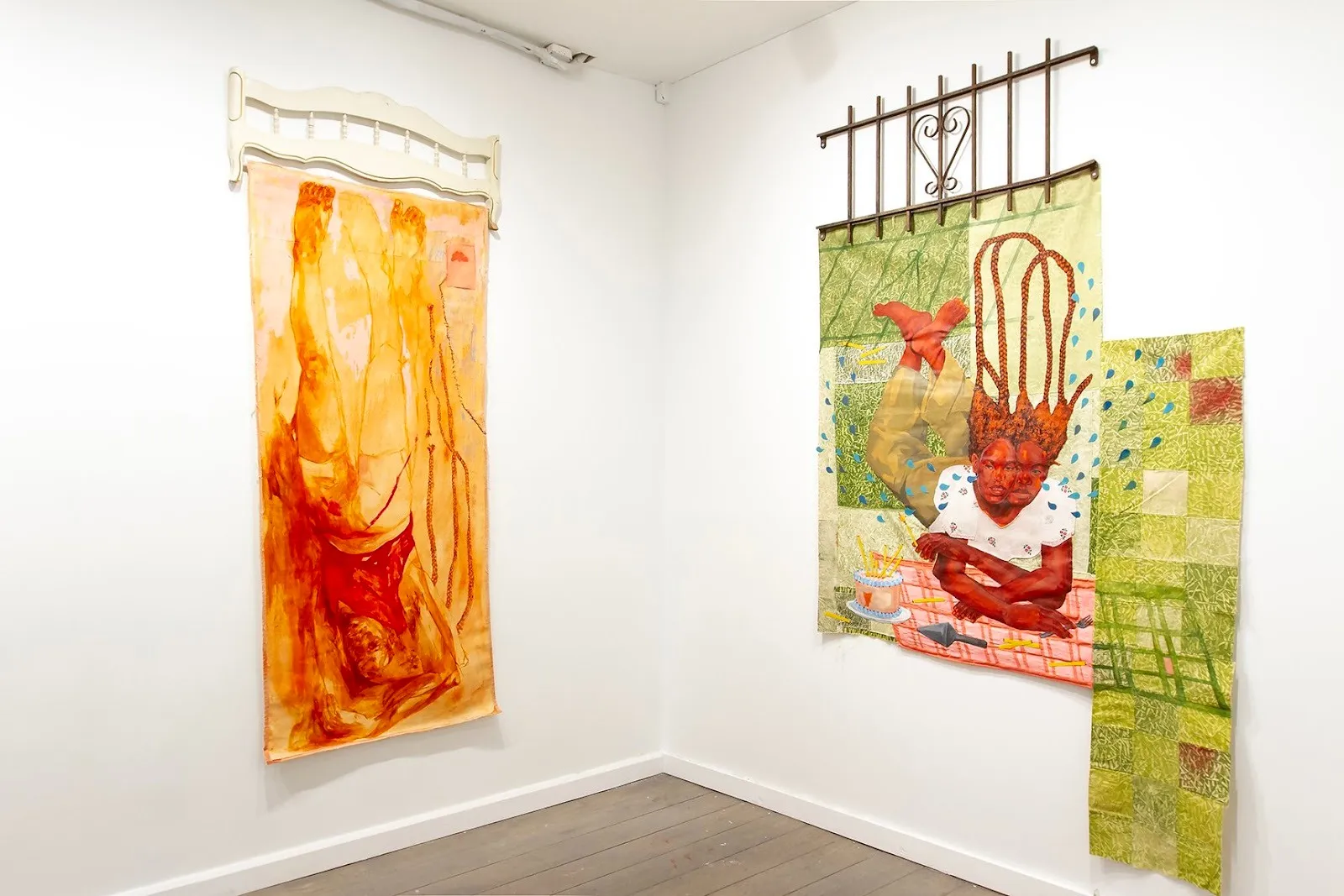 Installation view of Alexandria Couch’s works in Tender is the Night at Picture Theory, featuring large-scale figurative paintings on fabric in warm orange and green tones hung against white gallery walls.