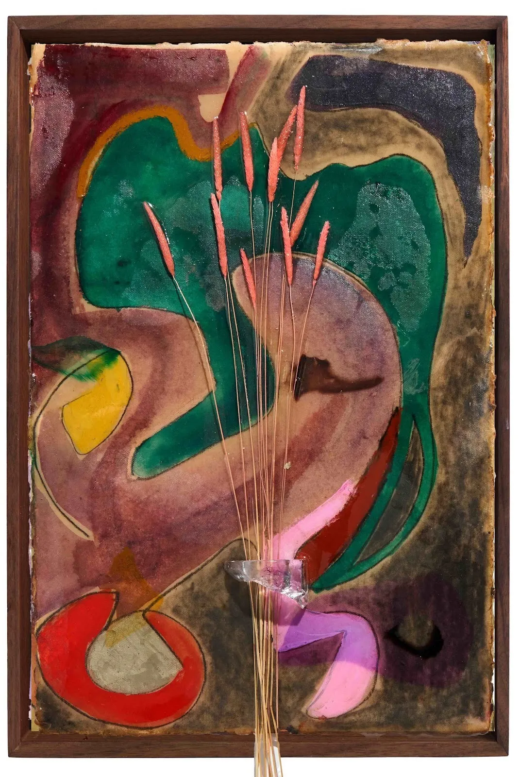 On a wood-framed, watercolored and resined surface of red, green, brown, blue, and yellow shapes, reed-like plants are adhered to the surface and stand vertically, bunched together by a jutting loop of clear resin.
