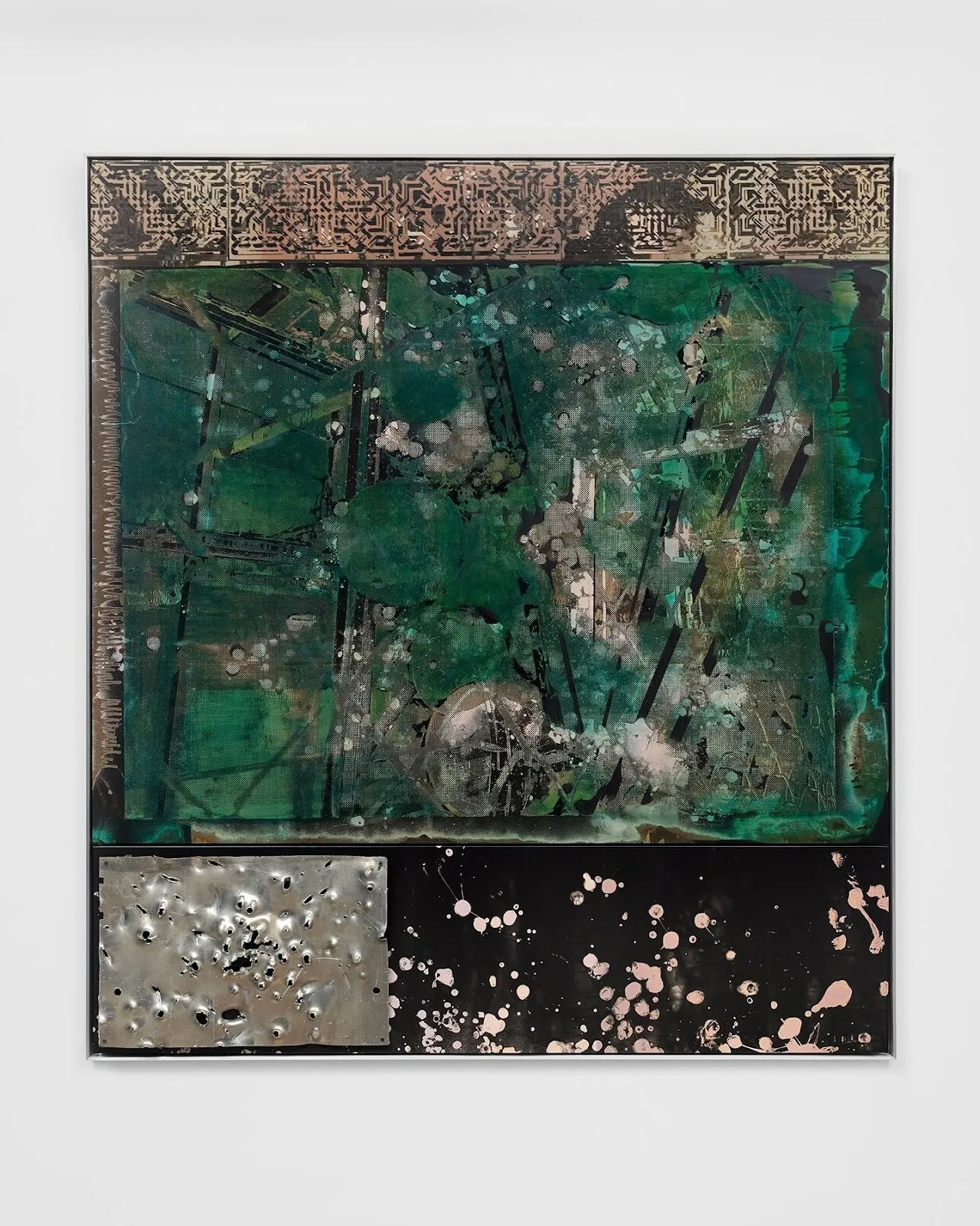 A 2-D work mounted to a white wall features splatters and brushtrokes of white and green in addition to a bullet hole-ridden metal rectangle on the bottom left and a band of geometric ornamentation on the top of the work.