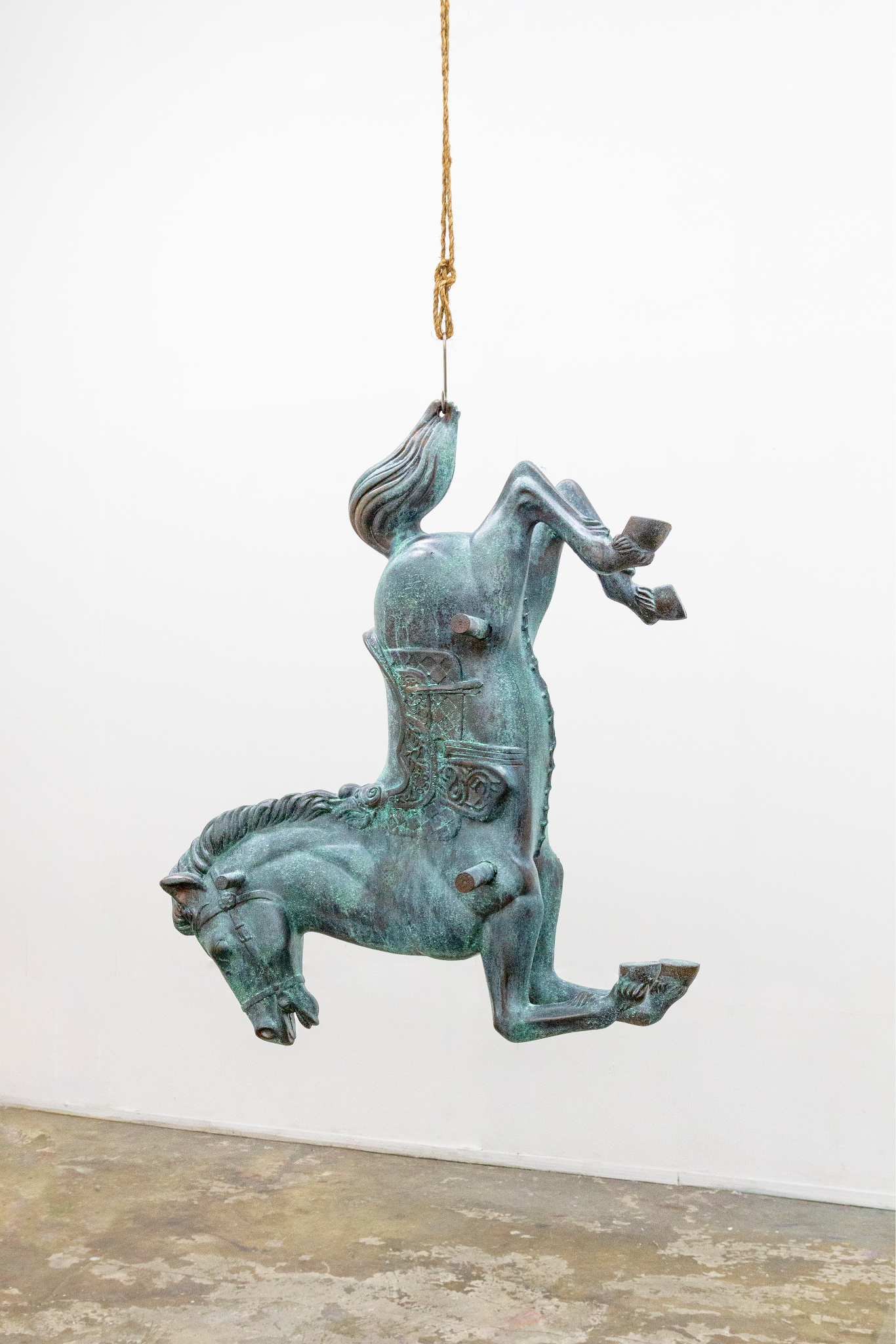 Hanging green-blue figurative sculpture with a horse form.