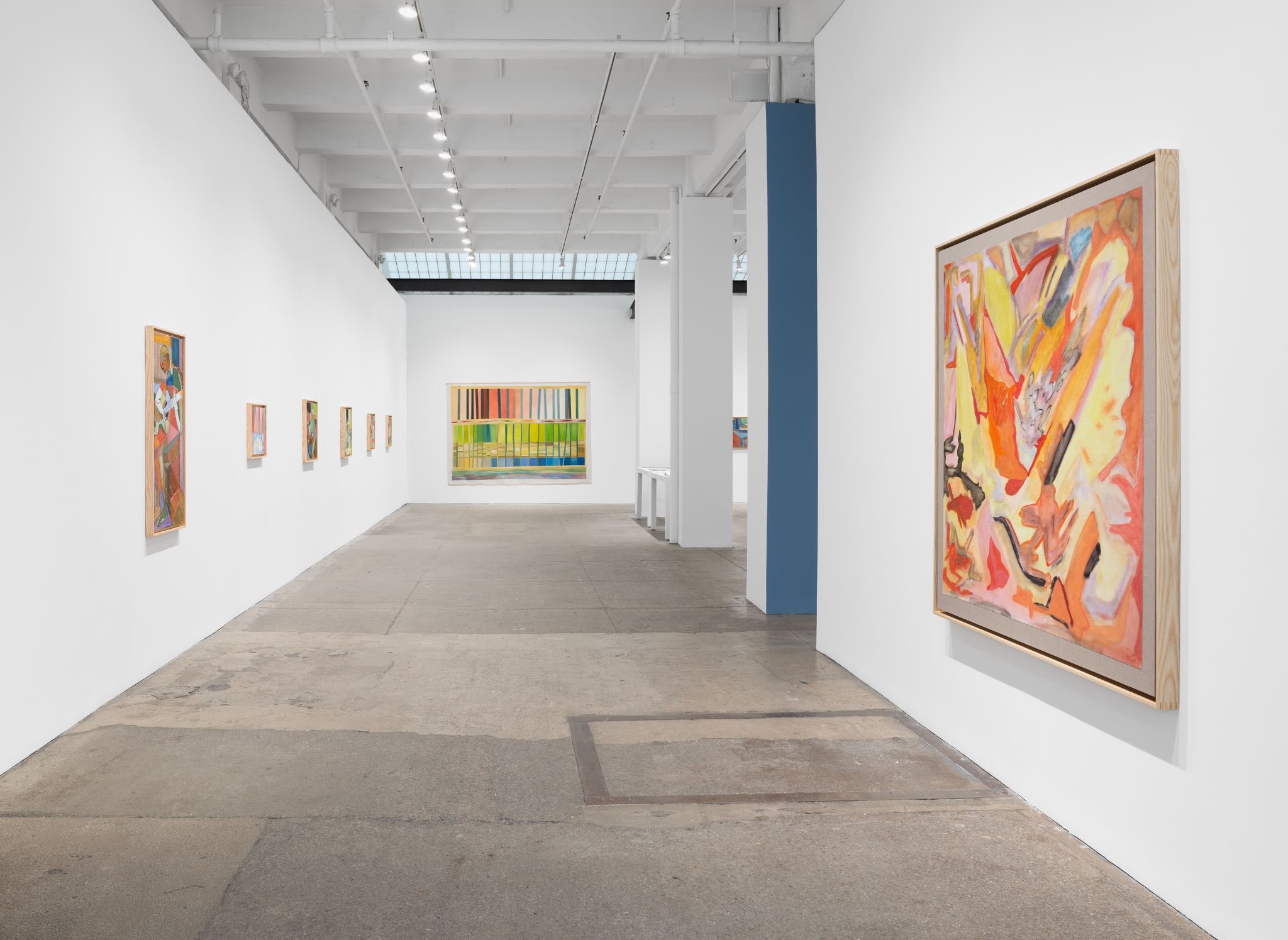 Wide view of a contemporary gallery exhibition with large abstract paintings displayed along white walls.