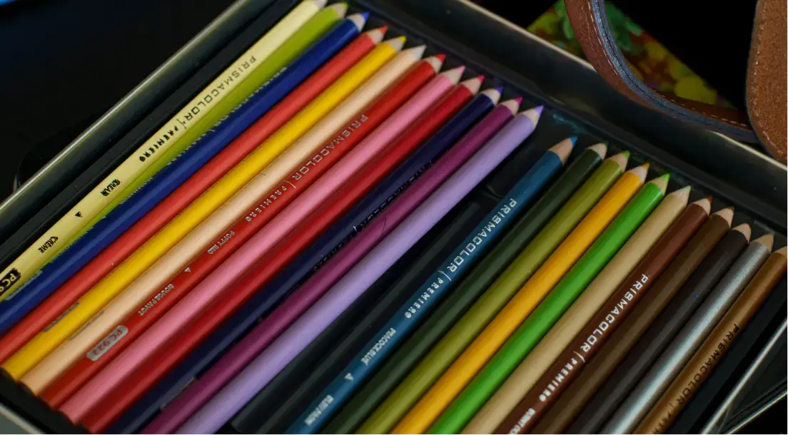 Box of colored Prismacolor Premier pencils arranged in parallel rows.