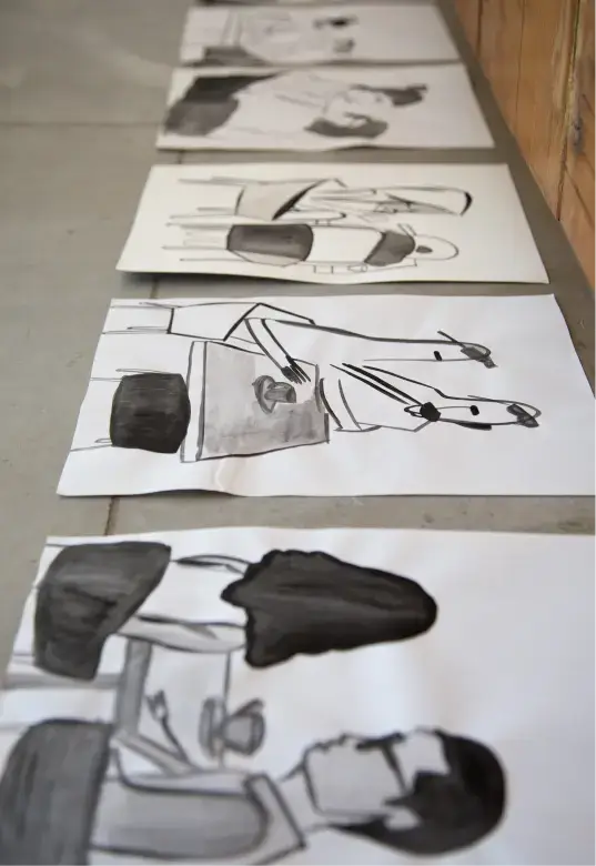 Black and white sketches of people seated at tables lined up on a floor.