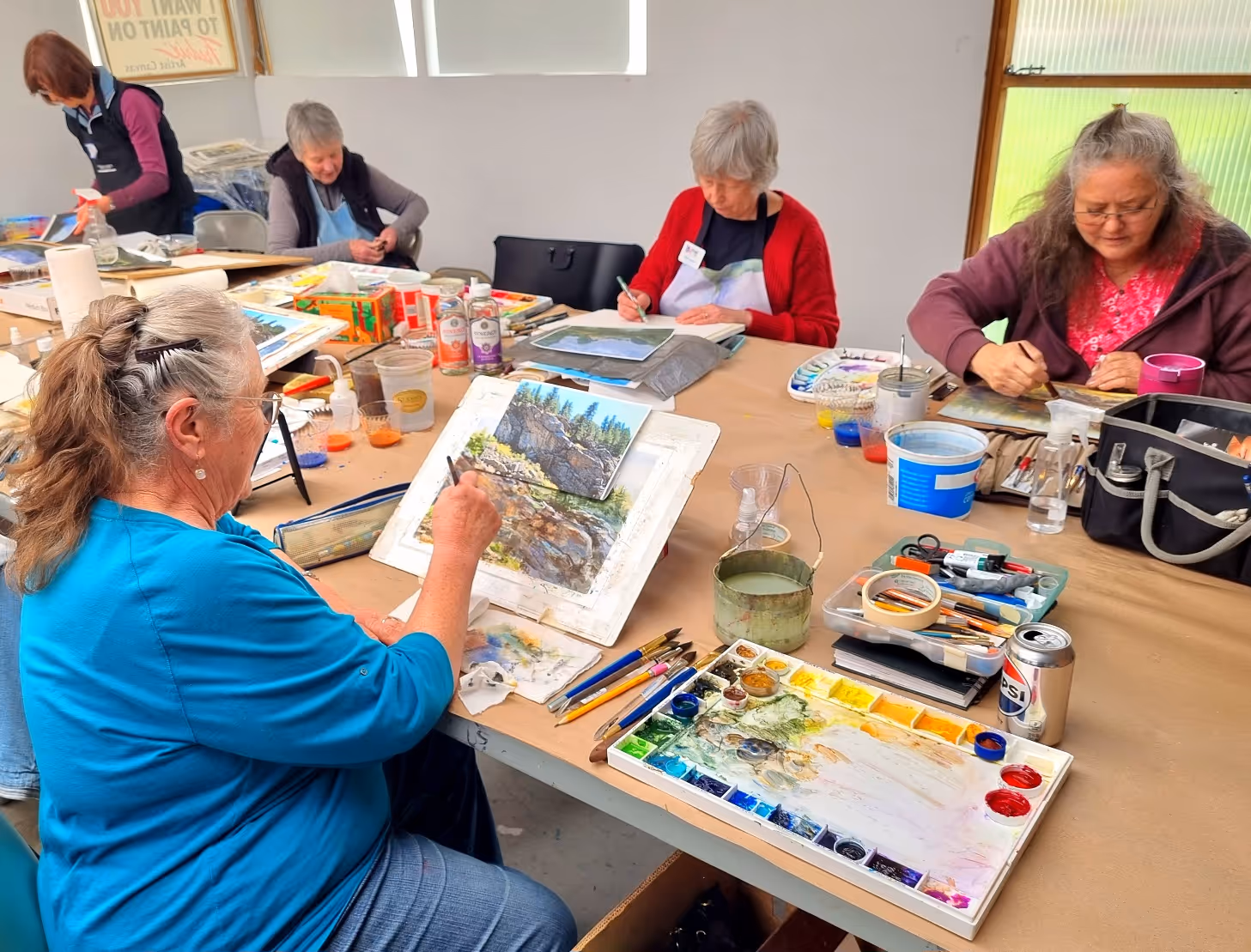 A candid photo of a woman painting 