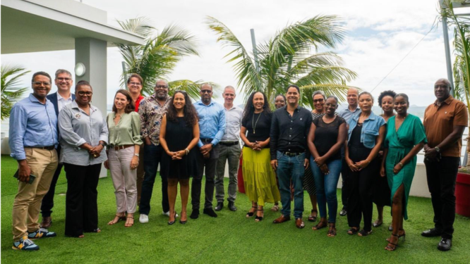 Three boys outdoors, smiling and laughing together. One boy playfully touches another's head. Their joyful expressions convey happiness and friendship.