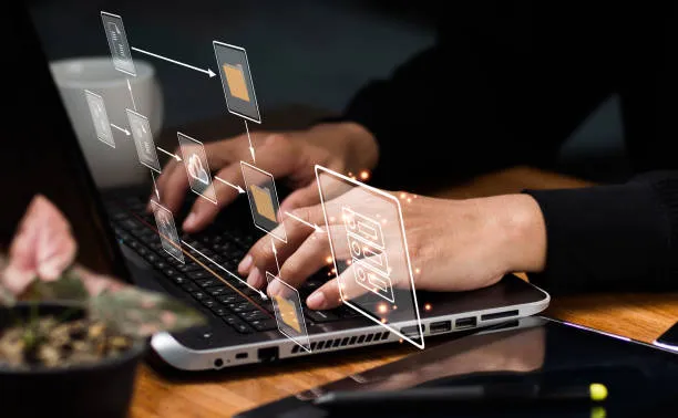 A close-up of hands typing on a laptop with a digital overlay of an organized file folder workflow and data icons, symbolizing cloud storage solutions and efficient IT systems management.