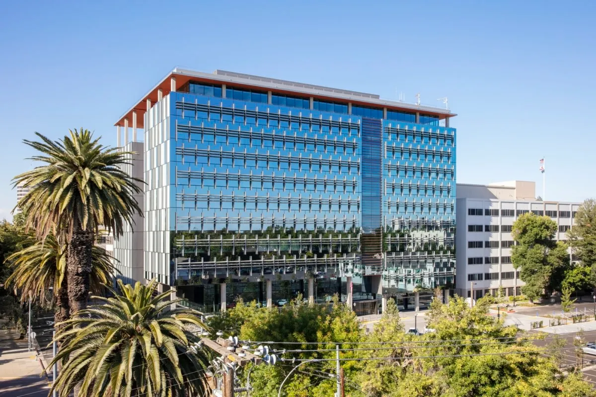 The modern architectural glass exterior of a California state agency office building, representing public sector infrastructure projects managed by E.K. Associates.