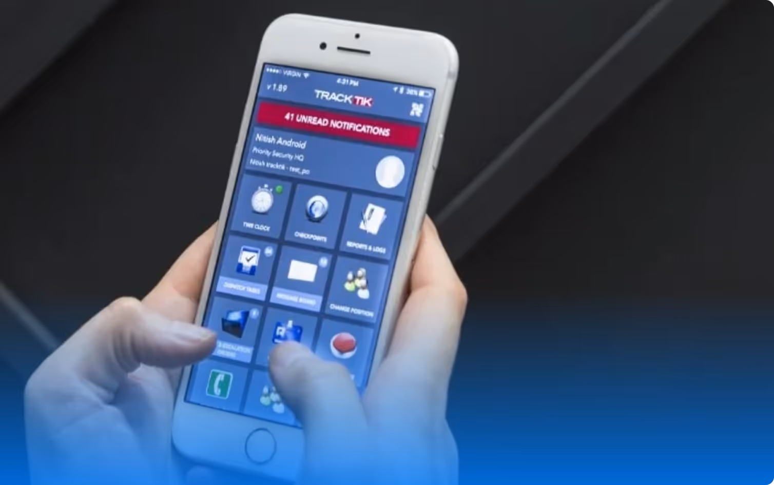 Person holding a smartphone displaying the TrackTik app interface with 41 unread notifications.
