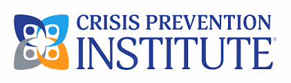Logo of Crisis Prevention Institute with stylized four-petal icon in blue, orange, and gray beside the text.
