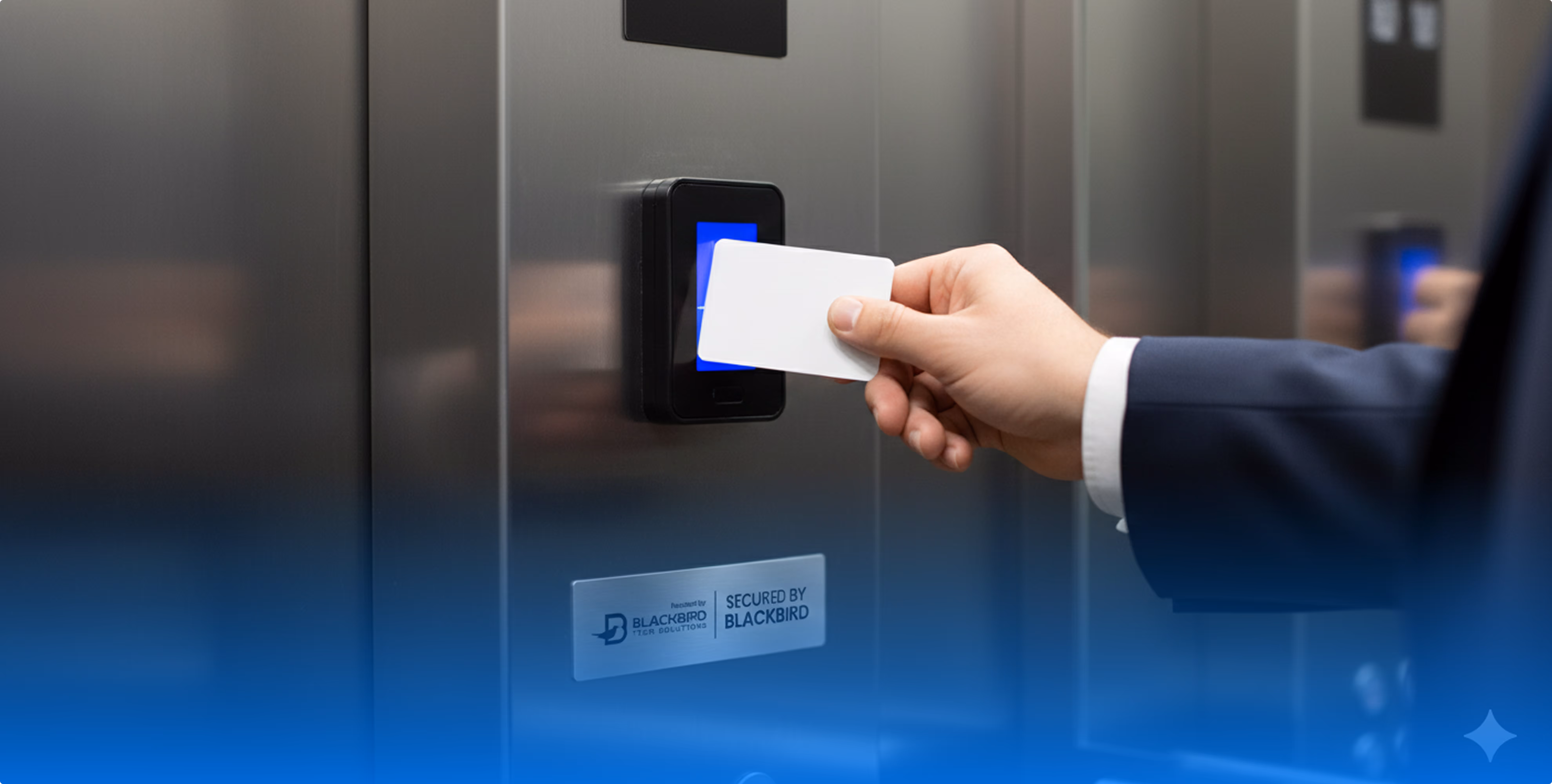 Person in suit holding a white access card to a blue-lit card reader on a secured stainless steel elevator panel.