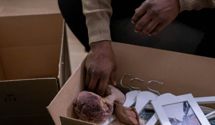 Packing pictures and fragile items with protective wrapping materials in moving boxes for safe transport