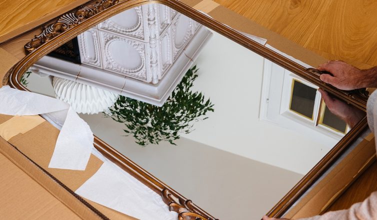 Moving mirrors safely with protective wrapping and cardboard packaging to prevent damage during relocation