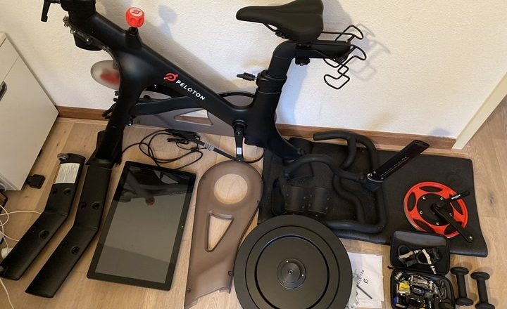 Peloton exercise bike disassembled with parts and accessories for moving
