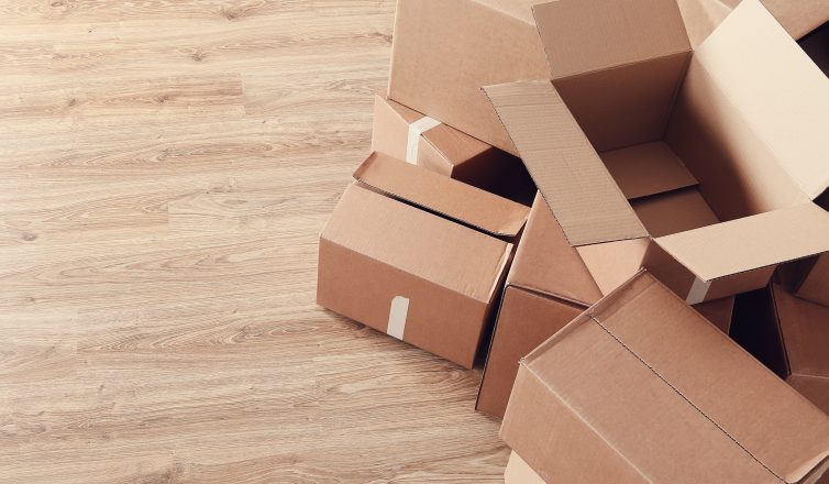 Empty cardboard boxes scattered on floor ready for packing and moving