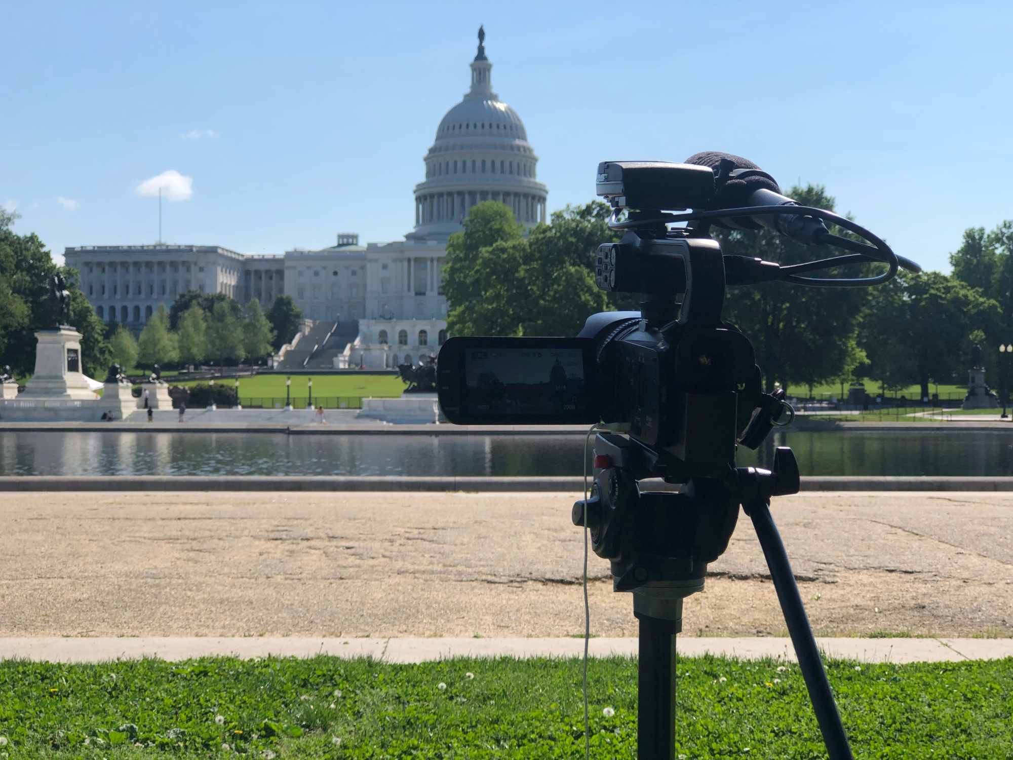 Graphic designer with arm tattoos using a stylus to draw on a digital tablet, showcasing creative pre-production and character design for film