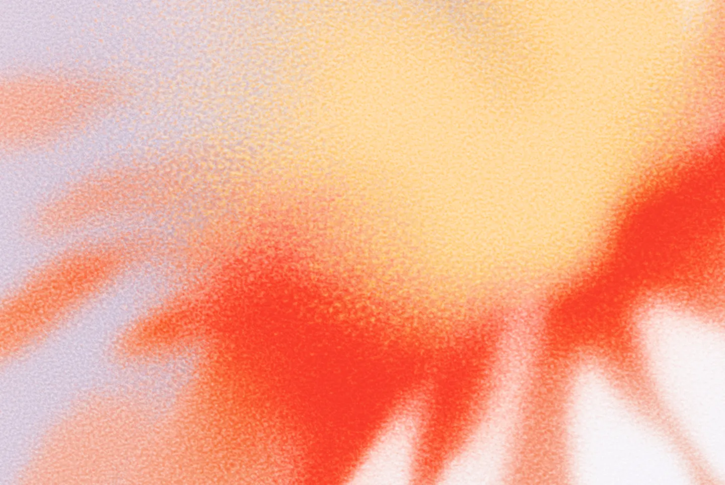 Abstract gradient background with soft textured blending of yellow, red, and purple colors.