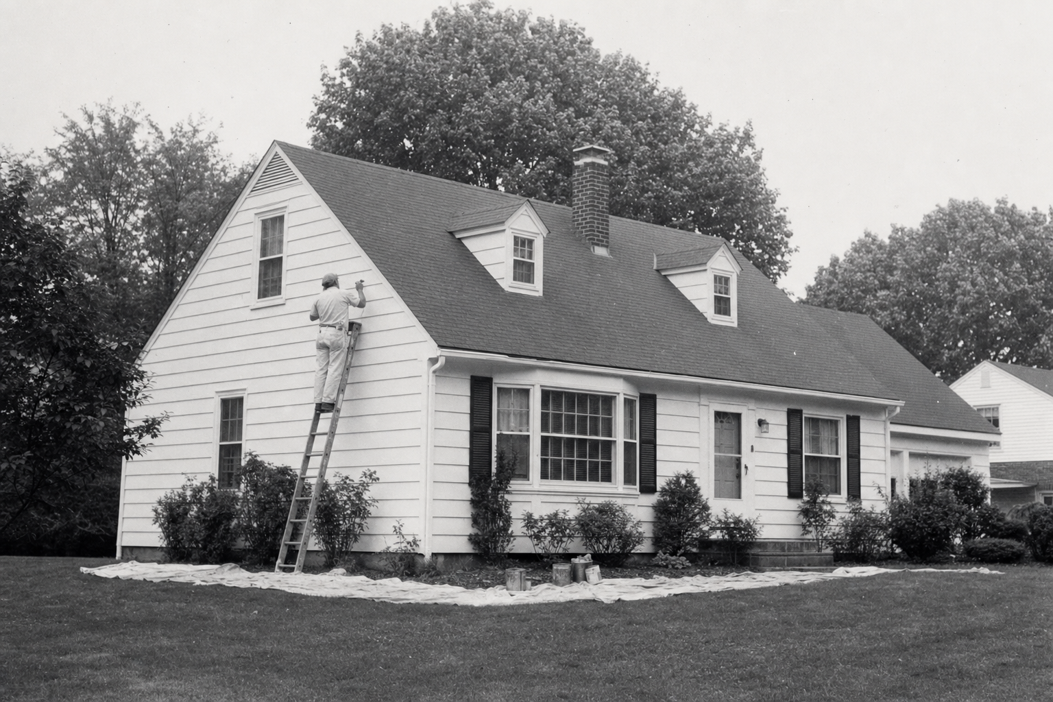 Painter working on a house exterior — the family craft passed on to Vasy Painting