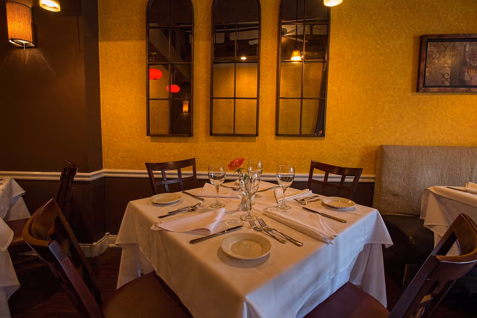 Set table for four with mirrors on the wall