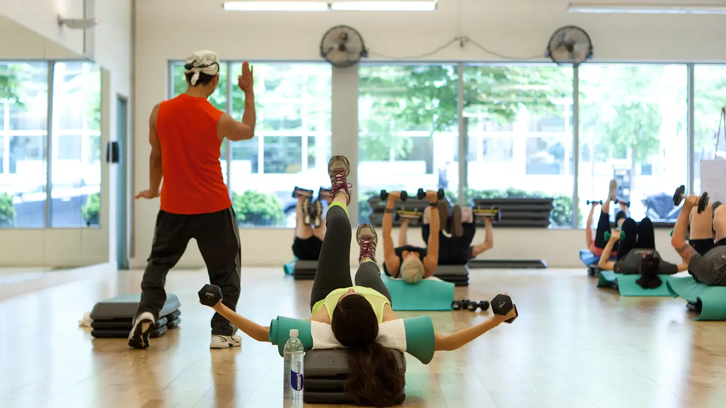 A woman is doing a workout in a gym.