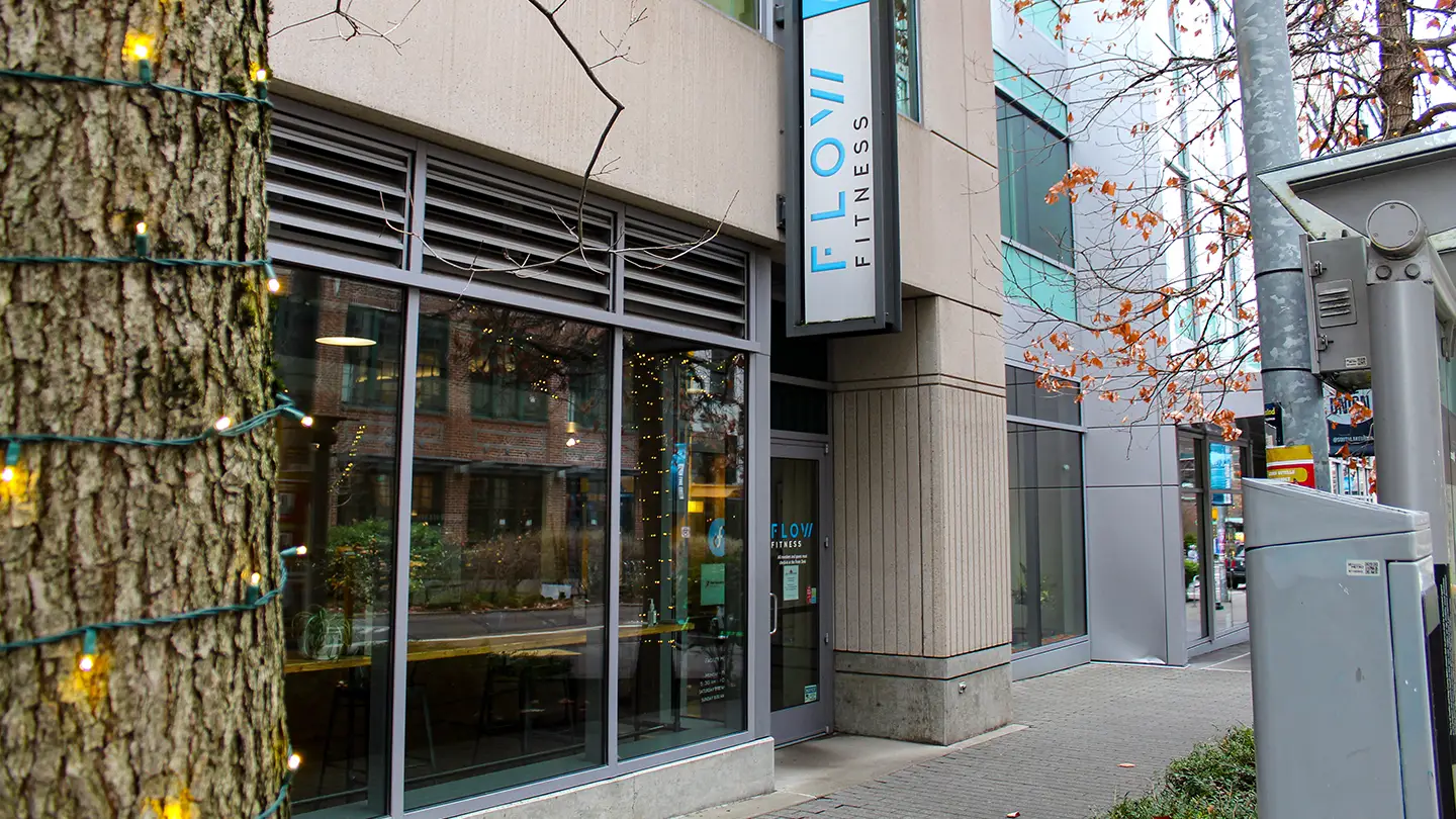 A gym with a sign that says "FloW Fitness".