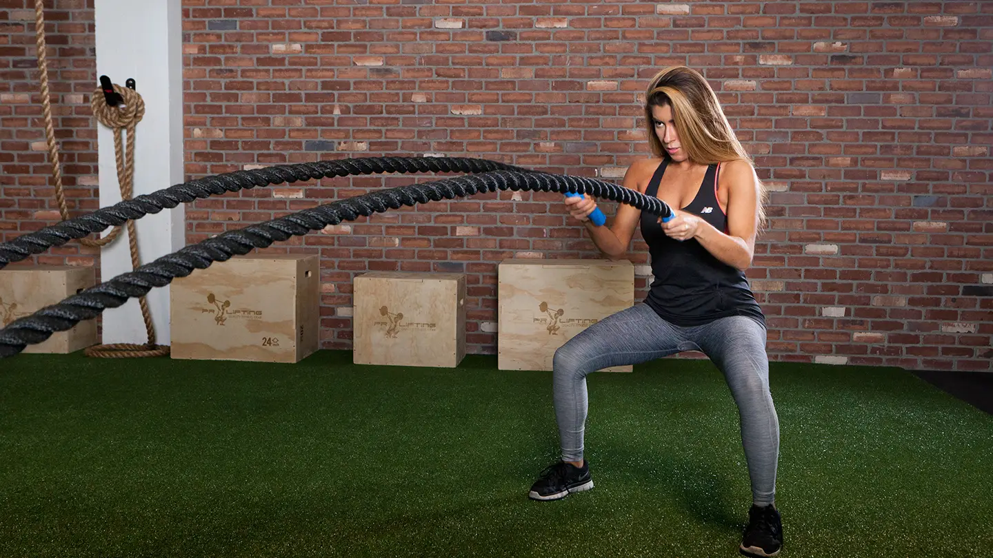 A woman is doing a workout with a resistance band.
