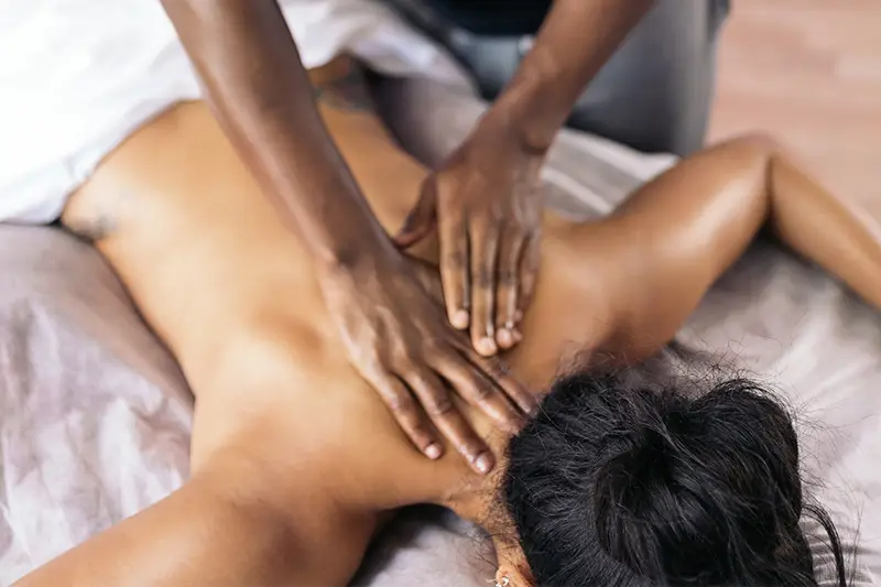 A woman getting a massage from a man.