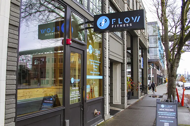 A gym called Flow Fitness is located on a street corner.