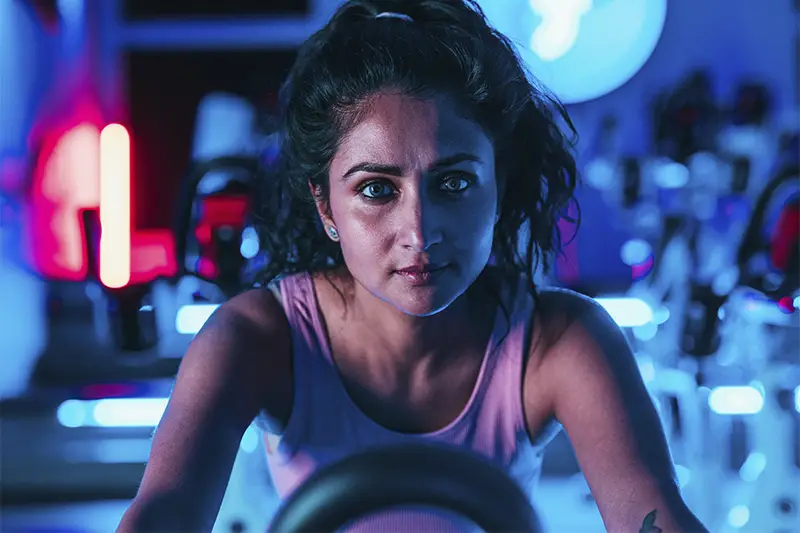 A woman with a tattoo on her arm is sitting in a car.