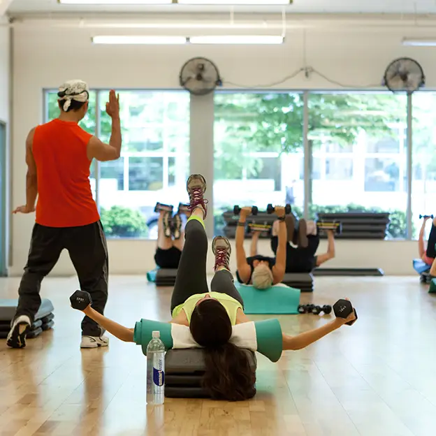 A woman is doing a workout in a gym.